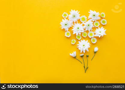 Composition of flowers, Chrysanthemums on yellow paper background. Copy space