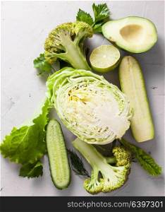 Composition of fresh green cut in half vegetables on a white background. Detox and diet concept