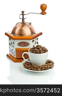 composition of manual coffee grinder and cup with beans