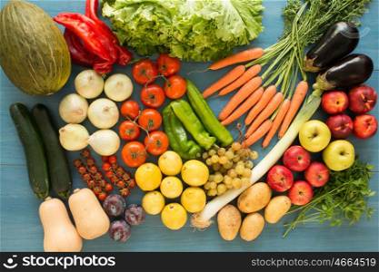 Composition with assorted raw organic vegetables on a blue wooden background