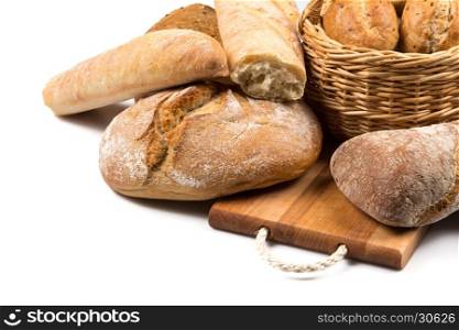 Composition with bread and rolls in wicker basket isolated on white