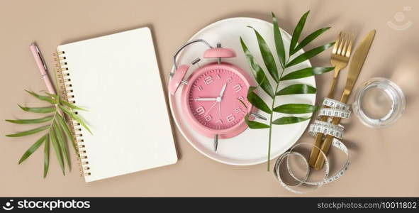 Composition with cutlery, plate, measuring tape, blank paper notebook, water, tropical leaves and alarm clock on color background, flat lay, top view, copy space