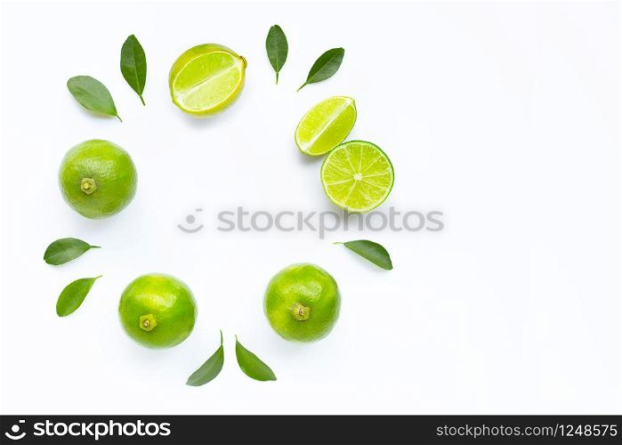 Composition with fresh limes on white background. Copy space