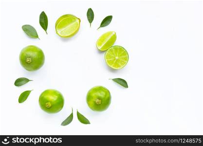 Composition with fresh limes on white background. Copy space