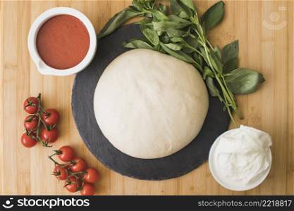 composition with green fresh organic basil ingredients pizza wooden backdrop