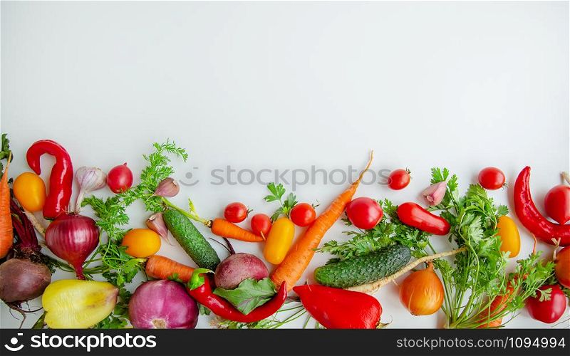 Composition with raw vegetables, tomatoes, peppers, carrots, eggplant, onions on a white background. Frame of vegetables, copy space for texts.. Composition with raw vegetables on a white background. Frame of vegetables.