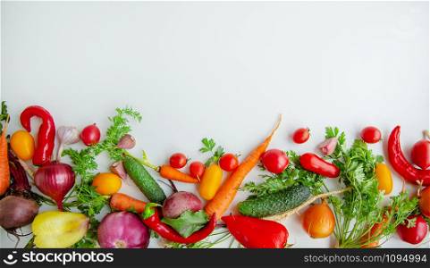 Composition with raw vegetables, tomatoes, peppers, carrots, eggplant, onions on a white background. Frame of vegetables, copy space for texts.. Composition with raw vegetables on a white background. Frame of vegetables.