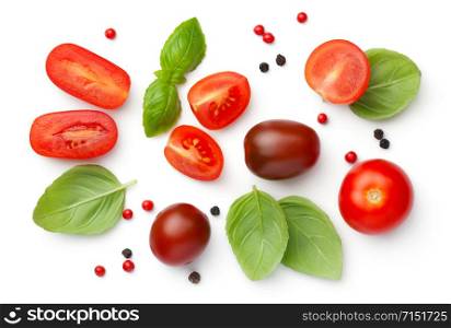 Composition with red, brown cherry tomatoes, basil and peppercorns isolated on white background. Top view