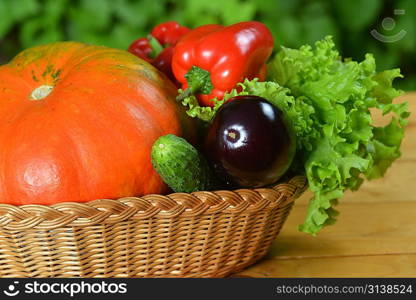 Composition with vegetables in wicker basket on wooden board