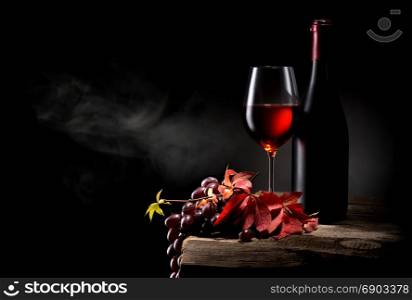 Composition with wine and grape on wooden table