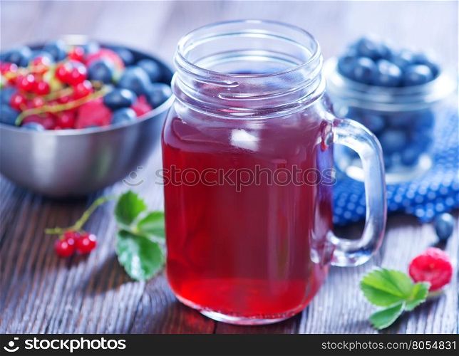compot from berries in glass and on a table