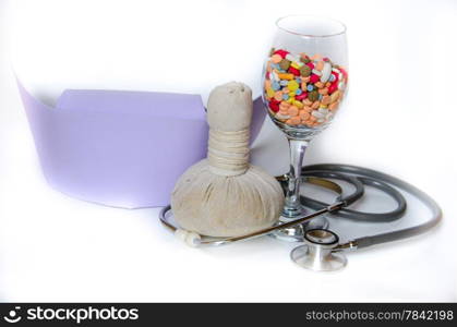 compress ball herbal with medicine and stethoscope