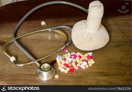 compress ball herbal with medicine and stethoscope