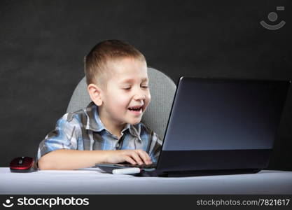 Computer addiction child boy with laptop notebook black background