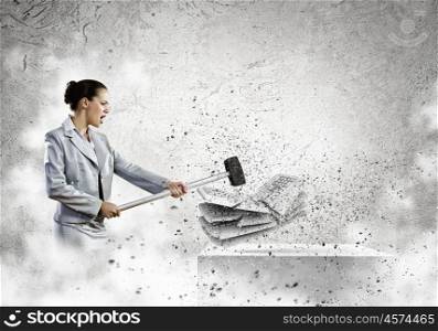 Computer addiction. Image of businesswoman crushing with hammer pile of keyboards