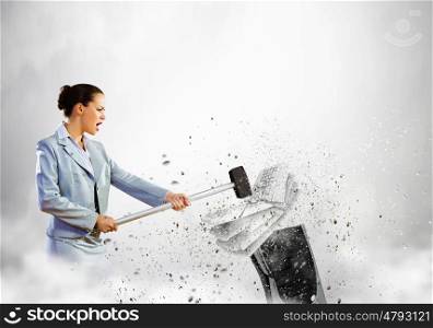 Computer addiction. Image of businesswoman crushing with hand pile of keyboards