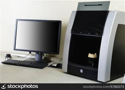 Computer and scanner on desktop in dental laboratory
