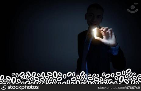 Computer binary concept. Businessman on dark background taking with fingers number one