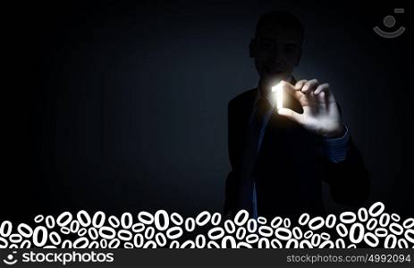 Computer binary concept. Businessman on dark background taking with fingers number one