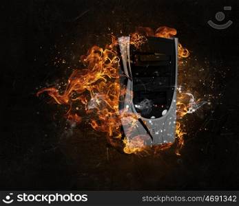 Computer burning with fire. Concept of electronics break with device in fire flames