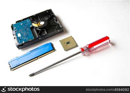 Computer components on a white background. CPU, HDD, DDR RAM, screw-driver