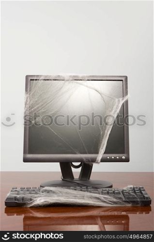 Computer covered in cobweb