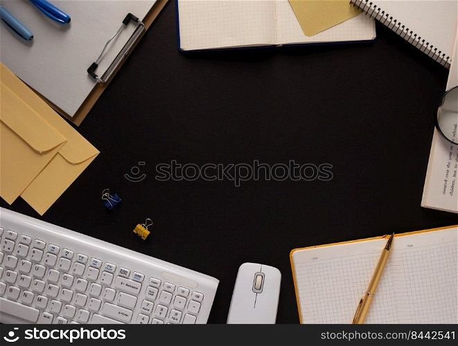 Computer keyboard and paper notebook at black background texture. Creative idea concept