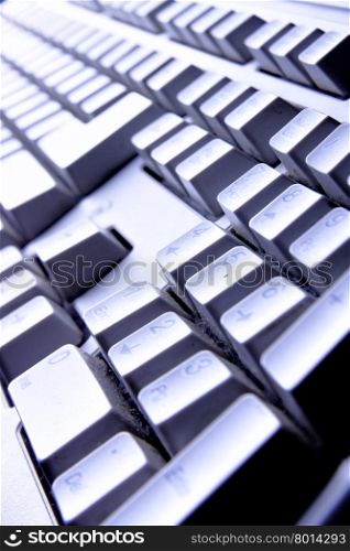Computer keyboard close up in blue light