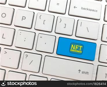 Computer keyboard enter button with NFT symbol. non fungible tokens concept