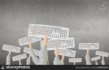 Computer keyboard. Group of business people holding keyboards in raised hands