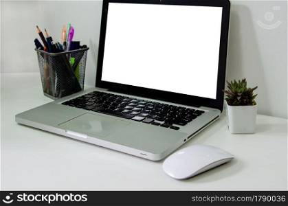 Computer laptop mock up blank white and mouse on desk.Used to put text or information to advertise news or sell products online. concept marketing business. Computer laptop mock up blank white and mouse on desk. Used to put text or information to advertise news or sell products online. concept marketing business