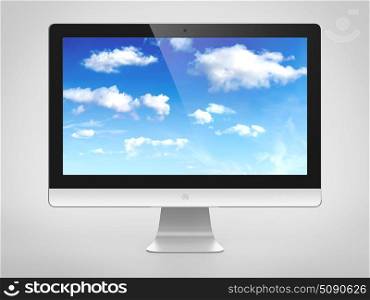 Computer monitor with cloudy sky image on screen. Cloud computing concept.