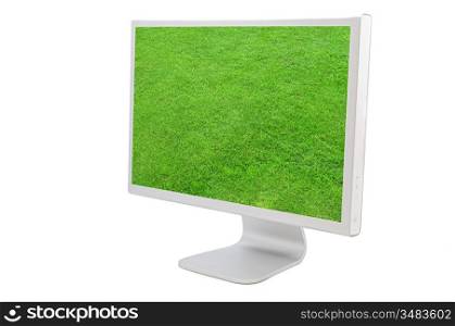 Computer monitor with the image of a green grass solated on white background