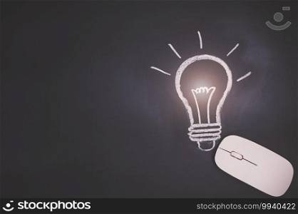 Computer mouse concep,  light bulb symbol on the blackboard represents an idea