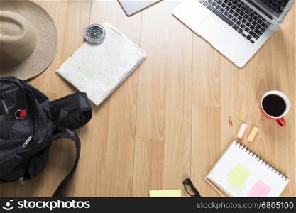 computer notebook, notepad and backpack on wooden desk