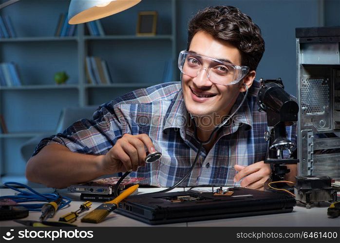 Computer repair concept with man inspecting with stethoscope