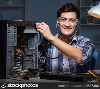 Computer repair concept with man inspecting with stethoscope. The computer repair concept with man inspecting with stethoscope