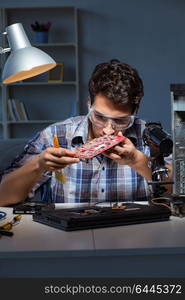 Computer repair man cleaning dust with brush