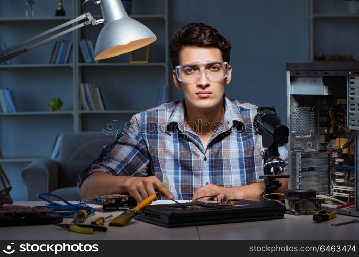 Computer repair man cleaning dust with brush