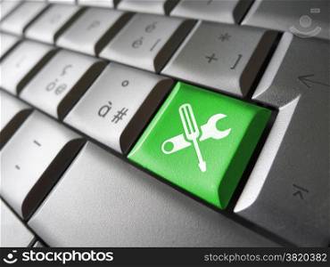 Computer repair service concept with work tools icons and symbol on a green laptop computer key for website and online business.