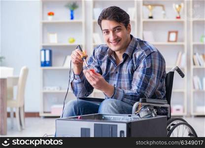 Computer repairman on wheelchair working