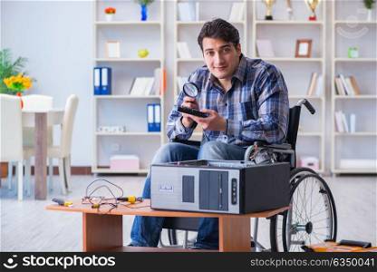 Computer repairman on wheelchair working