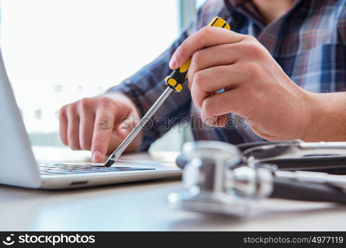 Computer repairman repairing computer laptop