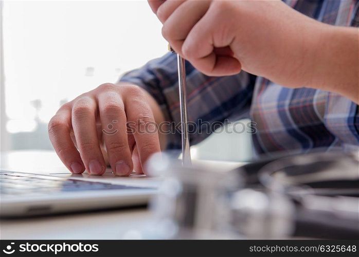 Computer repairman repairing computer laptop