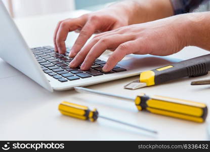 Computer repairman repairing computer laptop