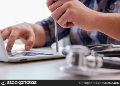 Computer repairman repairing computer laptop