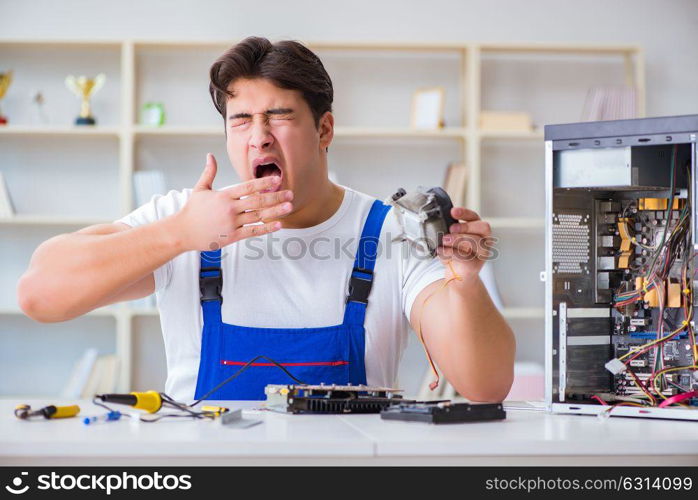 Computer repairman repairing desktop computer