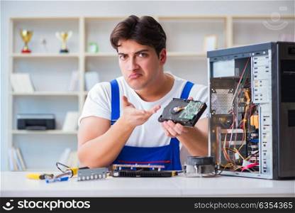 Computer repairman repairing desktop computer