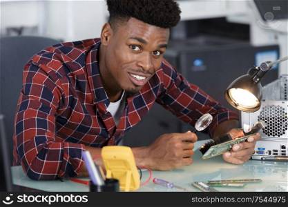computer repairman using magnifying glass