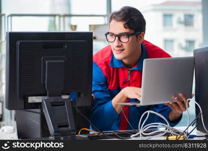 Computer repairman working on repairing computer in IT workshop. The computer repairman working on repairing computer in it workshop